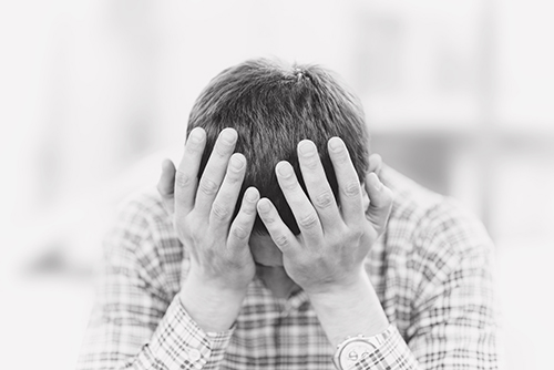 Sadness.Desperate young man crying in his hands.Worried man clos